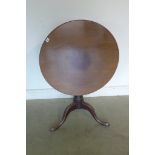 A George III mahogany tilt top side table, with a one piece 76cm diameter top on a gun barrel column