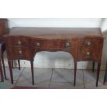 A Georgian mahogany serpentine shaped sideboard with four drawers raised on tapering legs - 158cm