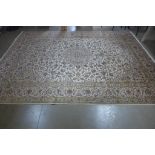 A hand knotted woollen Kashan rug, 392cm x 294cm - in generally good condition