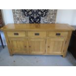 An oak three drawer three door dresser base, 85cm tall x 160cm x 42cm