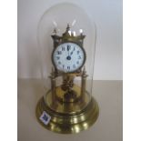 An anniversary brass clock, under a glass dome, 29cm tall