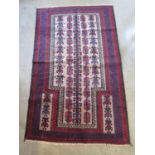A hand knotted woolen Old Baluchi rug - approx 147cm x 89cm - in good condition
