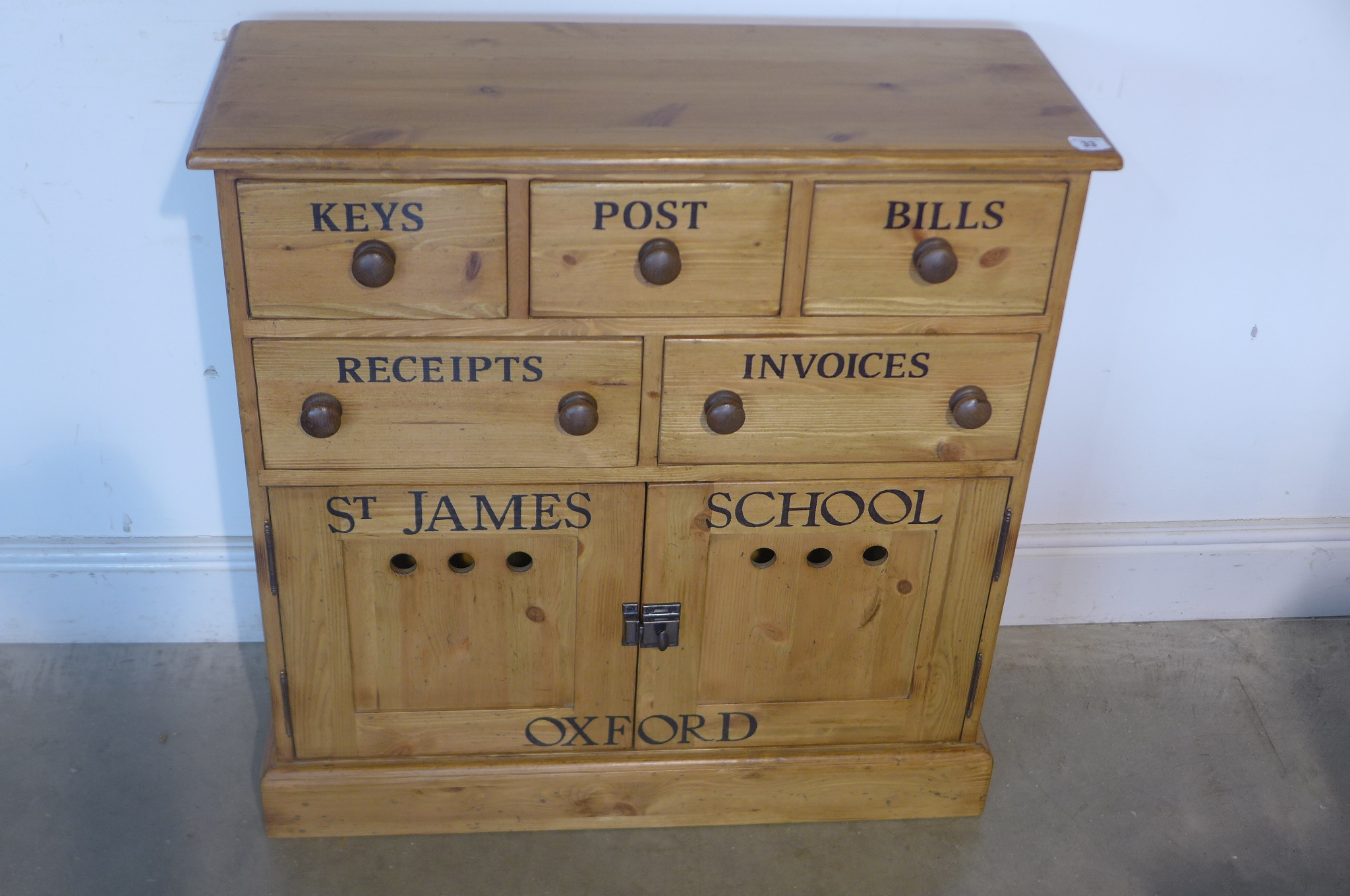 A pine storage chest with three drawers and two cupboard doors, 81cm tall x 77cm x 30cm