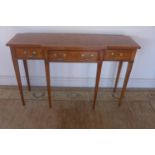 A breakfront walnut hall table with three drawers, raised upon tapered legs, approx 123cm W x 76.5cm