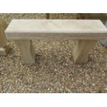 A limestone garden bench with chamfered top and carved detail to front, 92cm W x 48cm H