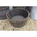 An oak whisky barrel planter 37cm high x 73cm wide