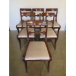 An exceptionally fine set of six Regency mahogany dining chairs on sabre front legs, fully