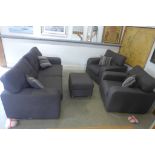 A brand new charcoal grey four piece suite with two seater sofa, two armchairs and foot stool