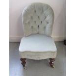 A Victorian button back nursing chair, 71cm tall