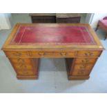 An Edwardian oak nine drawer twin pedestal desk with leather inset top, 73cm tall x 122cm x 63cm