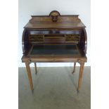 A good quality Edwardian marquetry inlaid cylinder top writing desk with a fitted interior above a