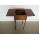 A Edwardian mahogany lamp/sewing table with fruitwood cross banding and ebony line inlays together