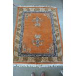 An oriental rug with an orange field, 210x150cm - some wear mainly to edges