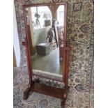 A 19th century mahogany cheval mirror on turned supports, 151cm tall x 83cm wide