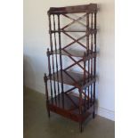 A mahogany waterfall five tier bookcase on turned supports and a base drawer, in good polished