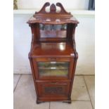 A late Victorian mahogany mirror backed cabinet with glazed door and a carved panel door, approx
