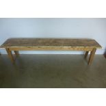 A rustic pine bench, 48cm tall x 190cm x 34cm