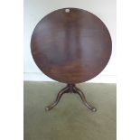 A George III mahogany tilt top table, with a one piece 82cm top in a turned Wrythern carved
