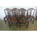 A set of six Georgian oak solid seat dining chairs