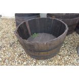 An oak whisky barrel planter 37cm high x 73cm wide