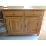 A solid oak two drawer two door cabinet - 107cm tall x 141cm x 55cm - matching previous lot