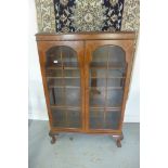 A circa 1930's walnut glazed cabinet bookcase with adjustable shelves, bares a label for Cameo