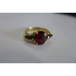 An 18ct garnet and diamond ring, size V, approx 6.7 grams, central stone approx 11mm x 9mm x 6mm -