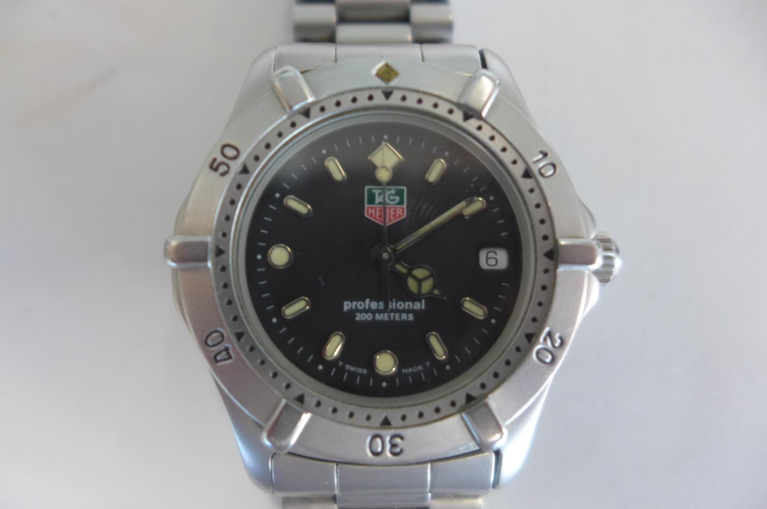 A Tag Heuer Professional gents mid range watch with steel case and bracelet, calendar, box and