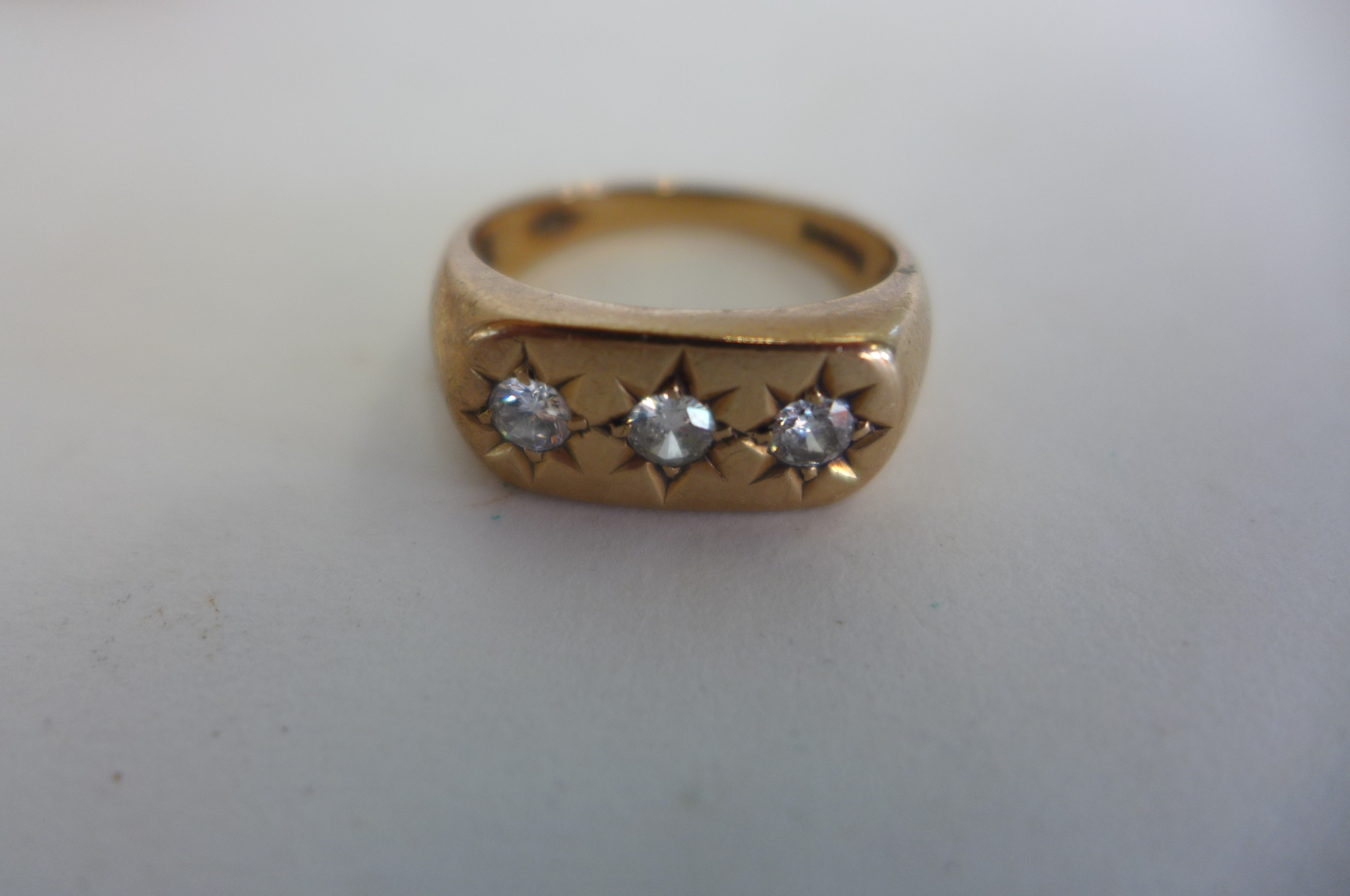 A 9ct gold three stone diamond ring, size T, approx 5.7 grams, some usage marks, diamonds bright