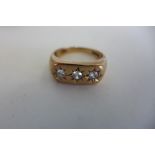 A 9ct gold three stone diamond ring, size T, approx 5.7 grams, some usage marks, diamonds bright