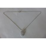 An 18ct white gold pendant set with small diamonds on an 18ct white gold chain, total weight