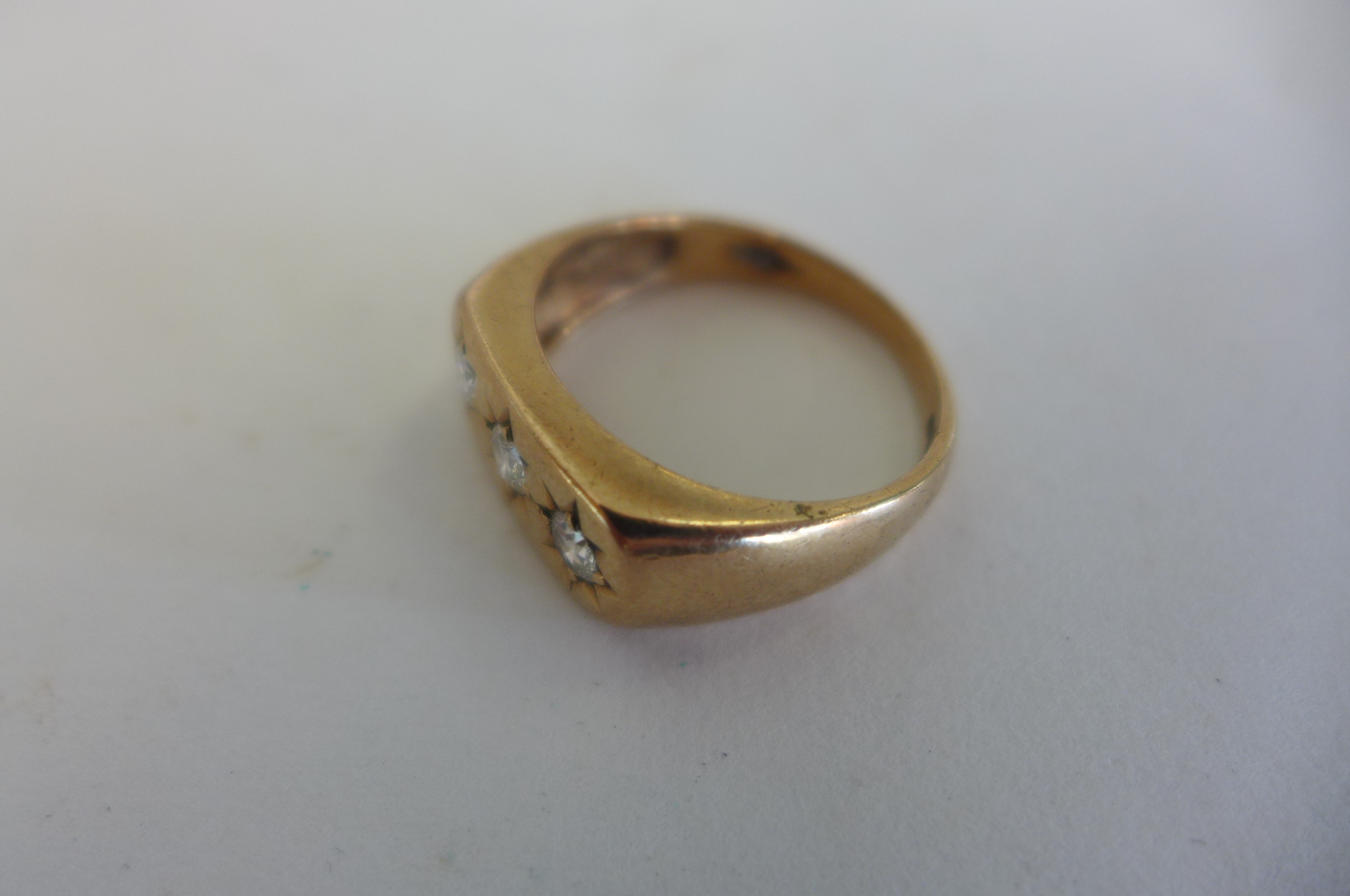 A 9ct gold three stone diamond ring, size T, approx 5.7 grams, some usage marks, diamonds bright - Image 2 of 3