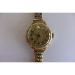 A 14ct gold ladies wrist watch on a gold plated strap - not working, hinge broken to watch