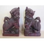 A pair of hardwood dogs of Fo, each approx 31cm, one dog damage to ear, other in good condition