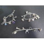 Three silver charm bracelets, all set with various charms, including lighthouse, animals etc -