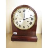 An 8 day mahogany silvered dial mantle clock, strikes hours/half hours