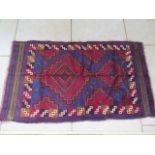 A hand knotted woollen Baluchi rug - 138x82cm