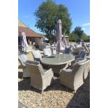 A Bramblecrest Patagonia oval table with a parasol, eight armchairs and cushions, RRP £2284, ex