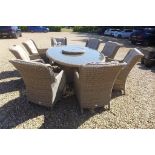 A Bramblecrest Oakridge oval table with alzy Susan eight armchairs and cushions, 220cm x 150cm - RRP