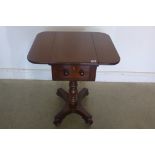 A 19th century mahogany work/lamp table with drop leaves and drawer supported on ring turned