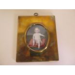 A well painted miniature of a young child in a brass oblong frame - 16x13cm