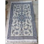 A good quality woollen rug, beige ground, with blues - approx 150cm x 90cm