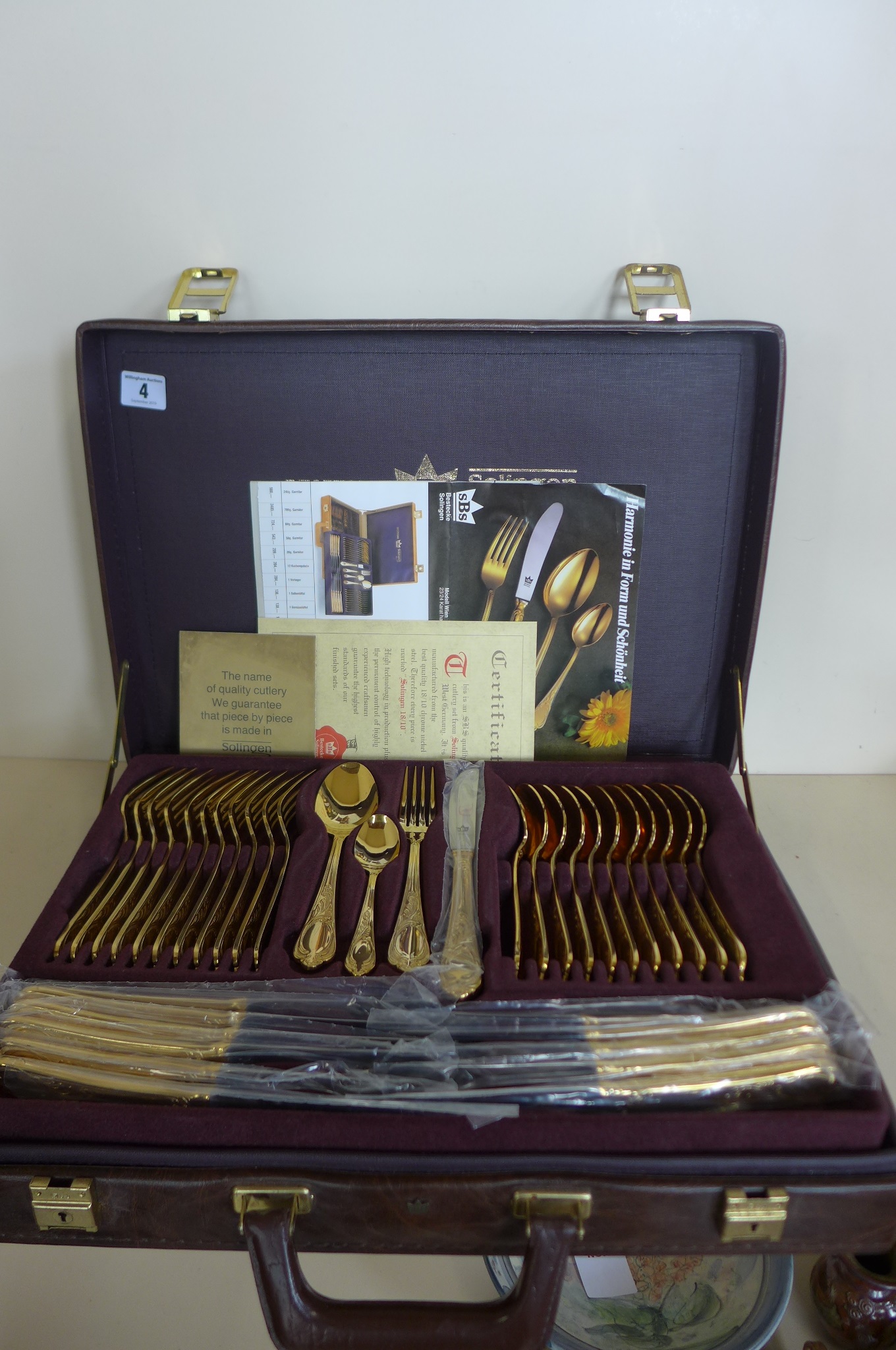 A SBS Bestecke Solingen gold plated twelve setting canteen of cutlery in fitted case, in unused