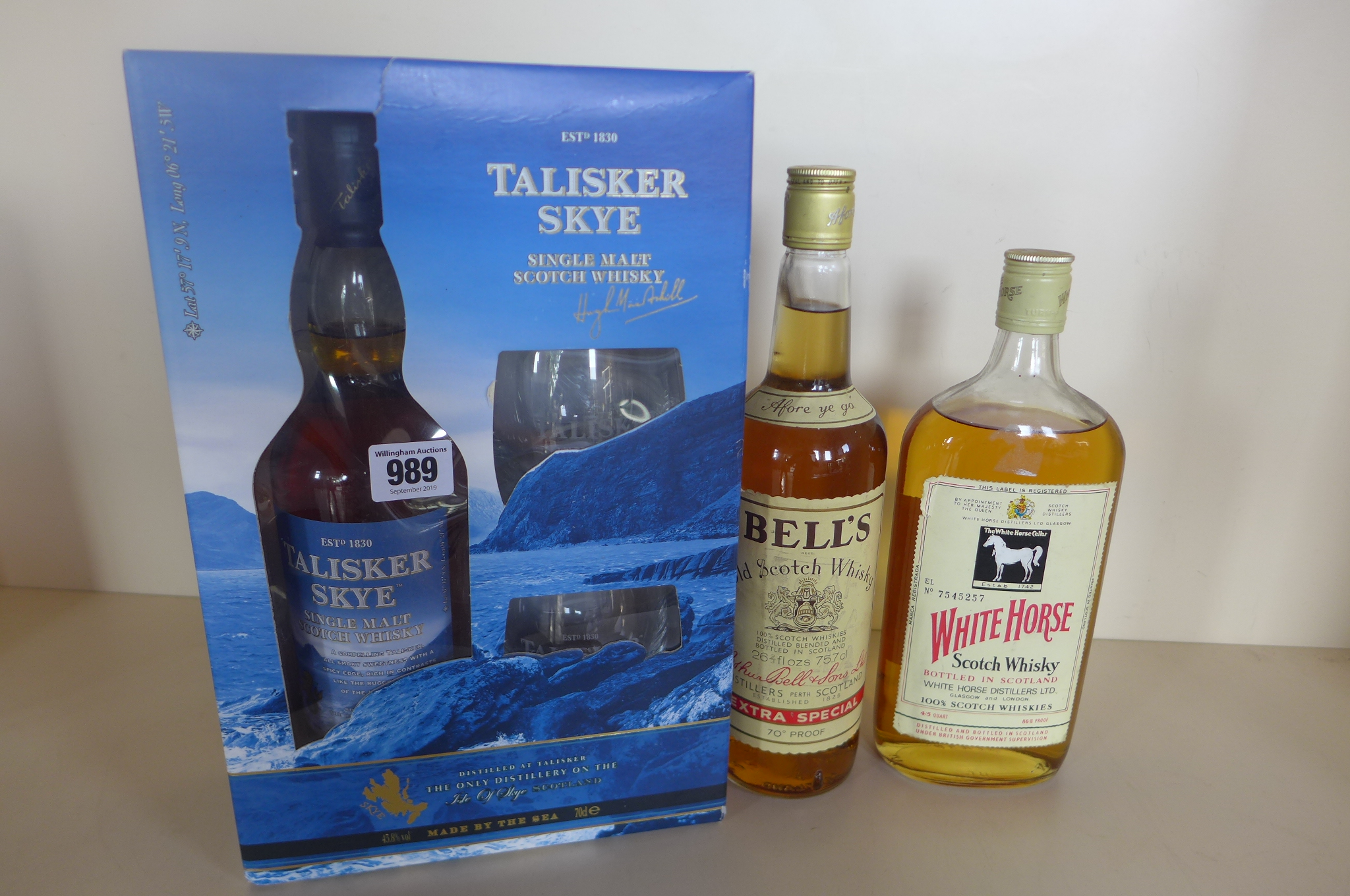 A Talisker Skye Atlantic Challenge boxed whisky and glass set, a bottle of Bells Old Scotch whisky