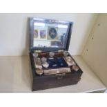 A 19th century coromandel travel box with fitted interior of plated top bottles and manicure pieces,