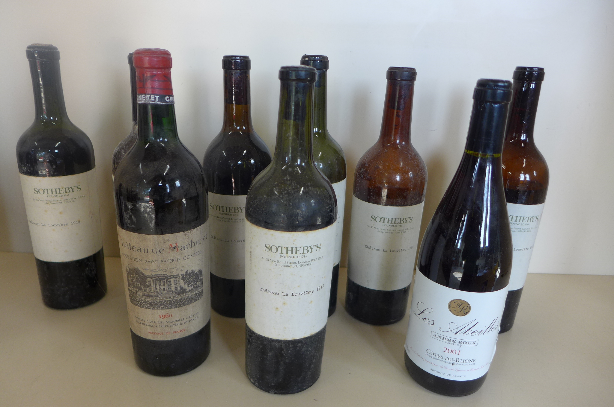 Seven bottles of Chateau la Louviere 1918 with Sotherby's labels, all levels low, corks exposed, a