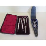 A set of four bright cut steel scissors in leather case, and a boxed set of plated nut crackers, and