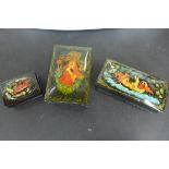 Three modern Russian lacquer boxes in black lacquer with hand painted decoration, all three with