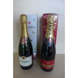 A bottle of Tattinger Brut Champagne, and a bottle of Piper-Heidsieck Brut champagne both boxed