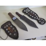 Two African iron daggers with polished carved cow bone handles, leather scabbard decorated with